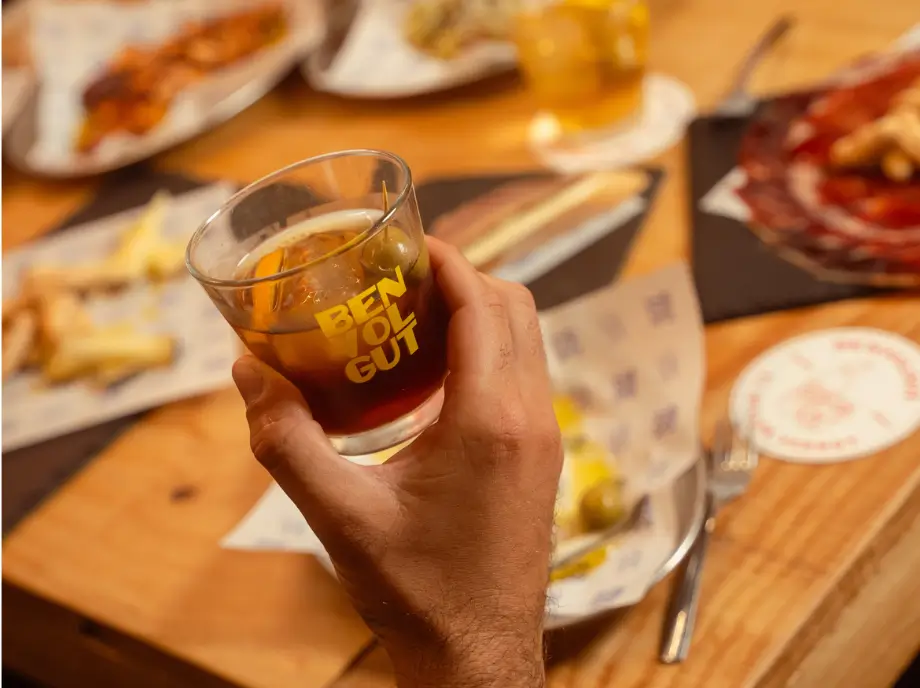 Glass of premium vermouth with orange garnish on tapas tour in Valencia.