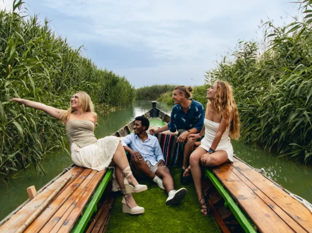 A group travelling around the Albufera lake in an electric boat.