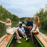 A group travelling around the Albufera lake in an electric boat.